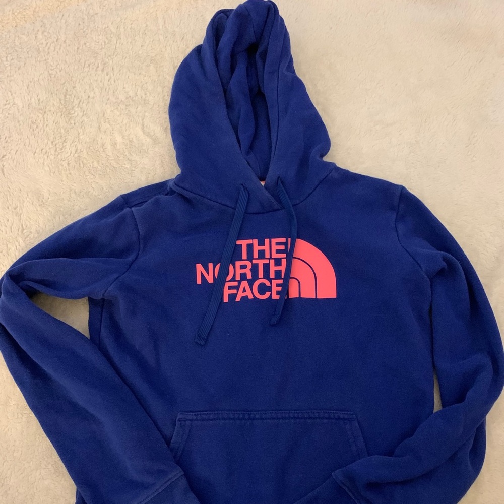 A blue and pink north face sweatshirt